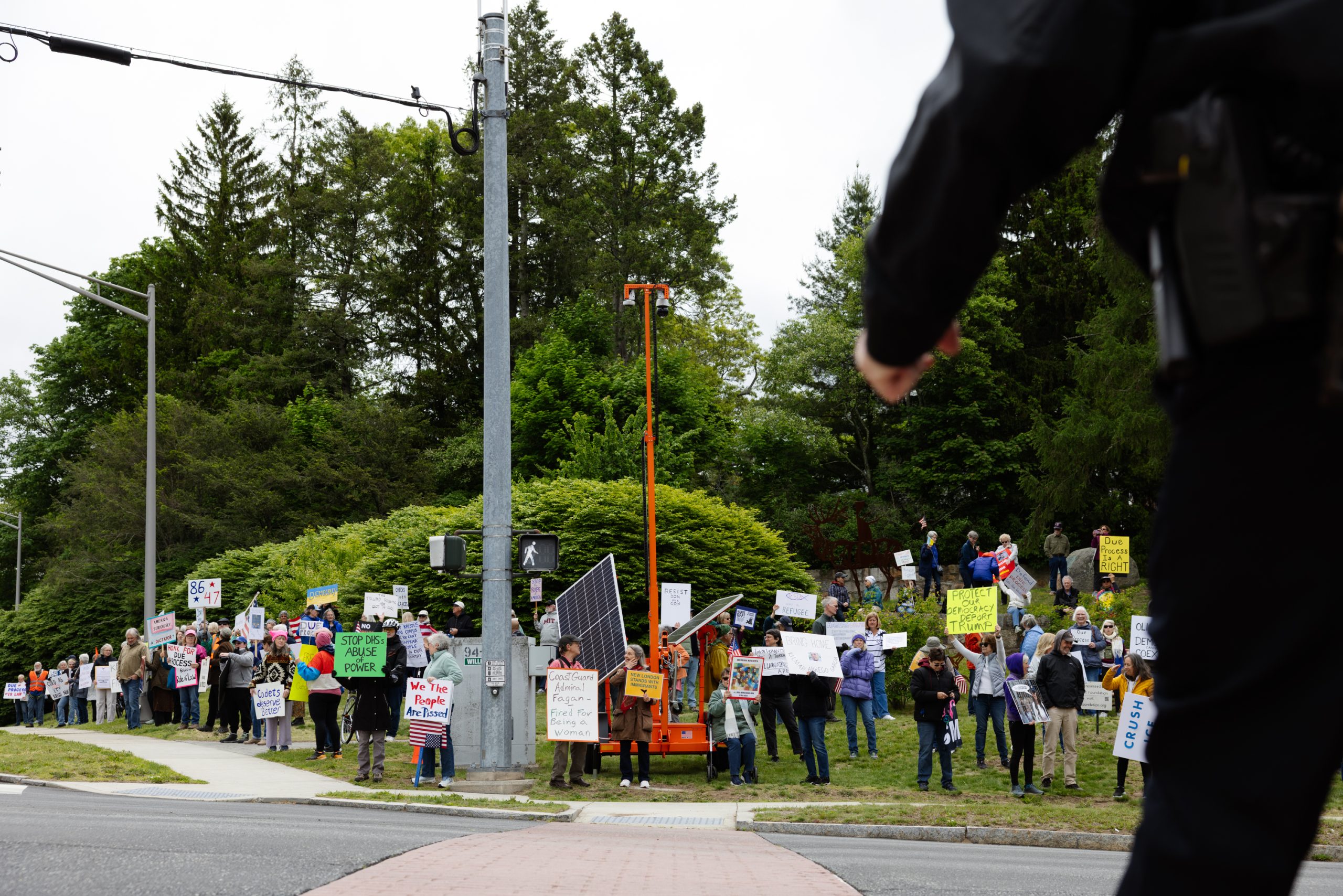 At Coast Guard graduation, Kristi Noem talks as protesters gather