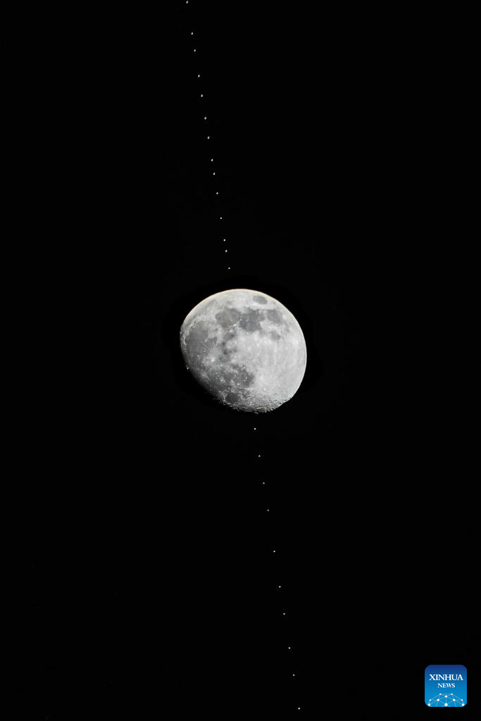 Snapshots of Chinese space station passing in front of Moon - People's Daily Online