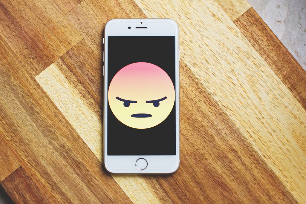Angry face emoticon on iPhone - freestocks.org - Free stock photo