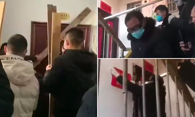 Police BARRICADE screaming woman in her home with iron bars in Wuhan to stop coronavirus spreading