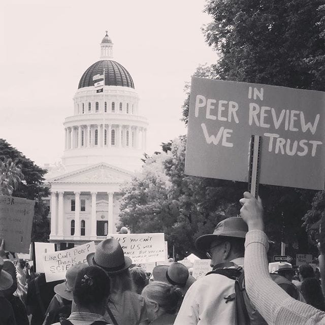 Photo: March for Science signs & Why Peer Review is Crucial • Andrew Crusoe
