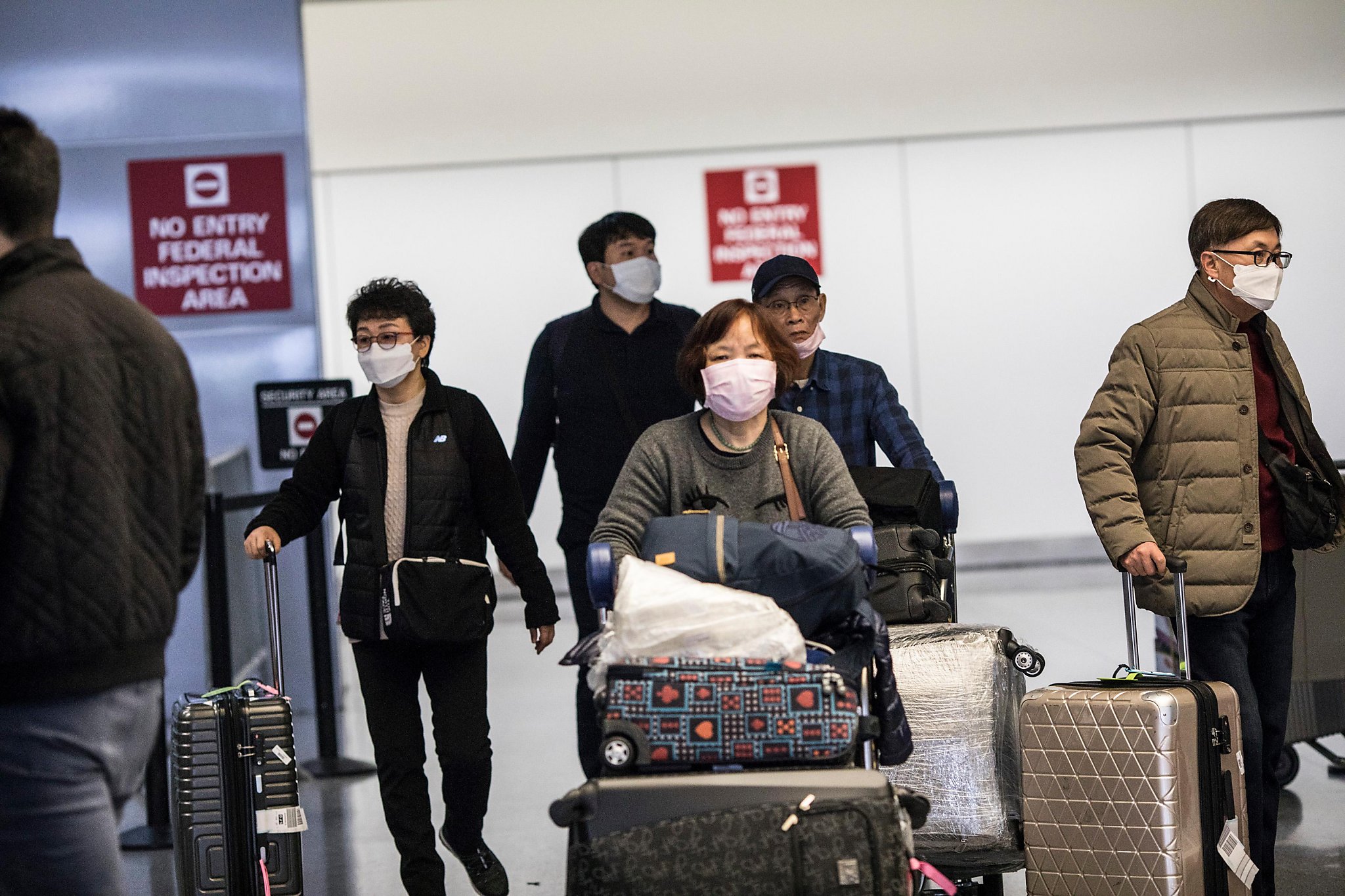 SFO: New coronavirus travel restrictions mean long waits for some