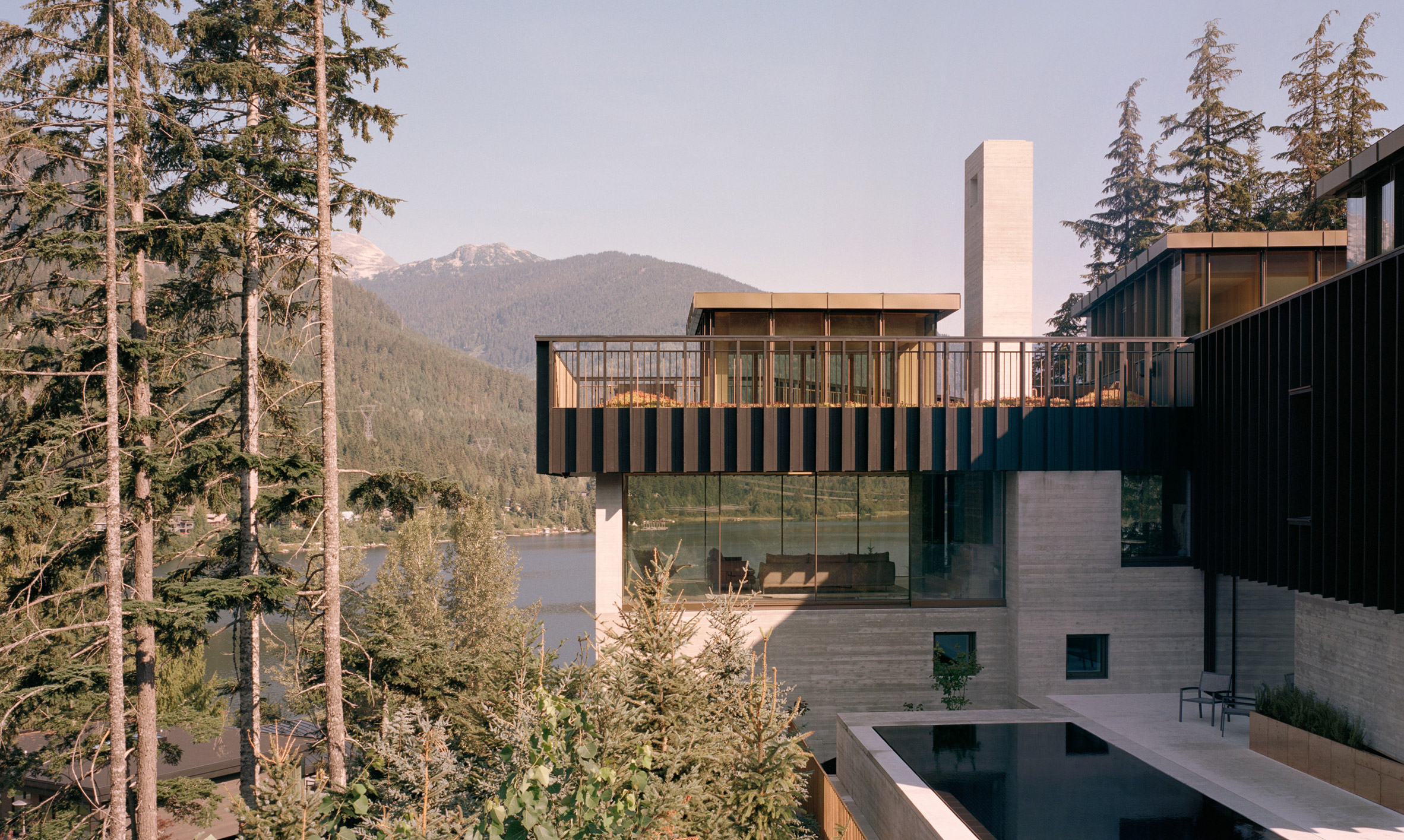 Concrete house by Gort Scott hugs rocky crag in Whistler